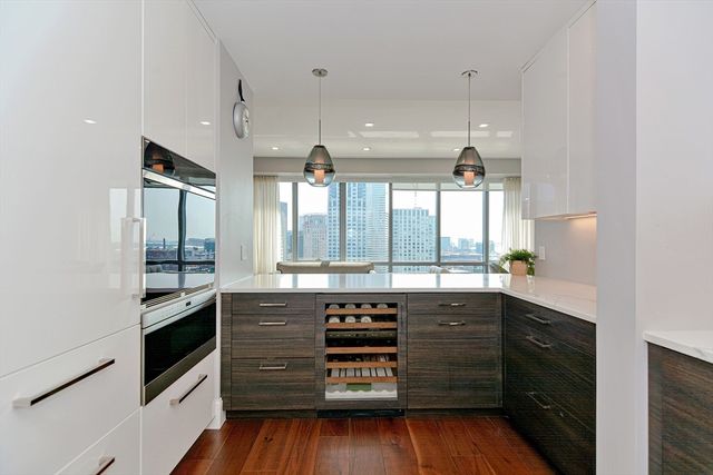 a kitchen with a sink and wooden floor