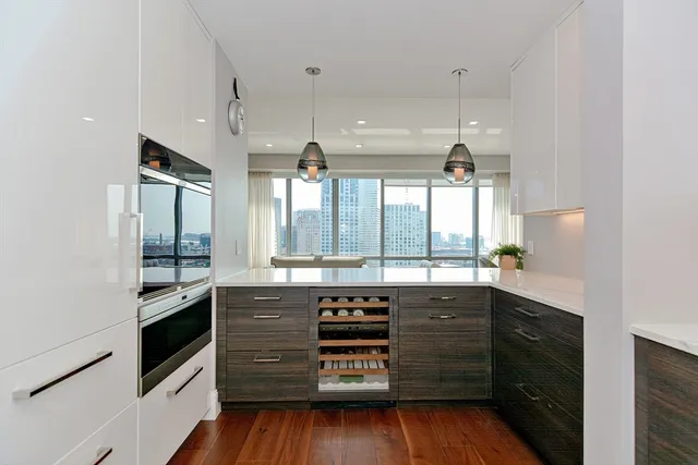 a kitchen with a sink and wooden floor