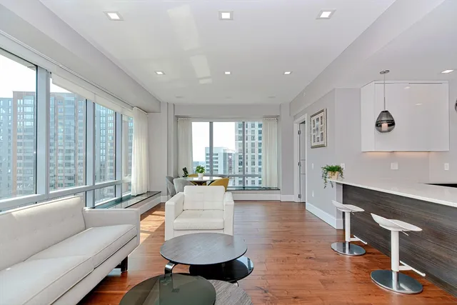 a living room with furniture and a large window