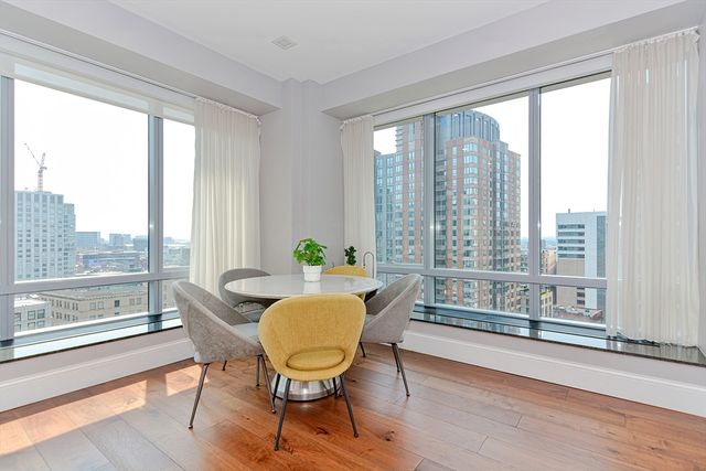 a view of a dining room with furniture window and wooden floor
