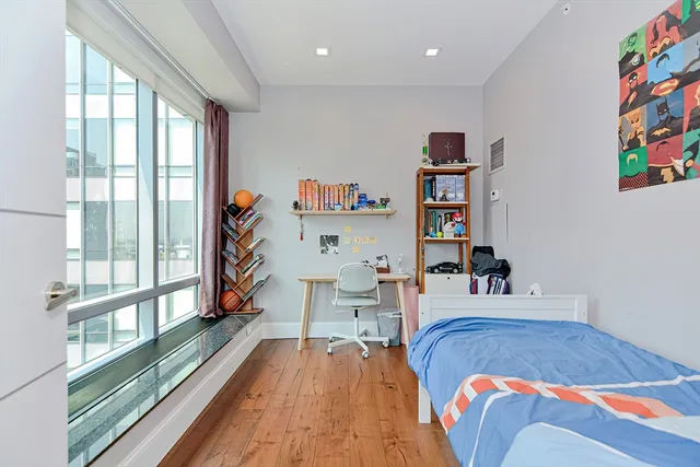 a bed room with a bed and a large window