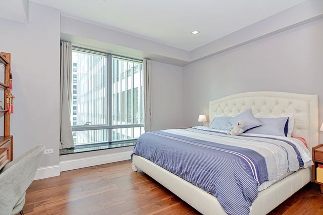 a bedroom with a large bed and a large window