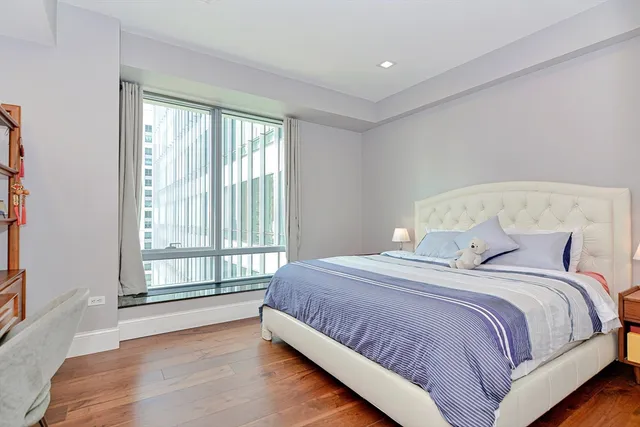 a bedroom with a large bed and a large window