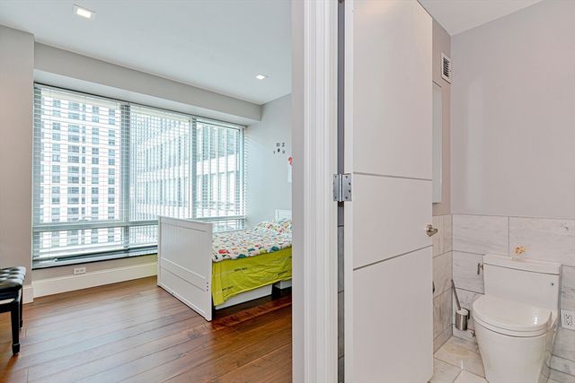 a spacious bedroom with a bed and a window