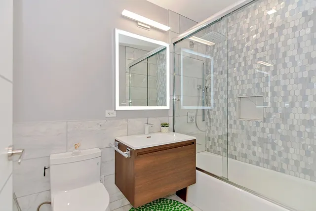 a bathroom with a sink toilet and shower
