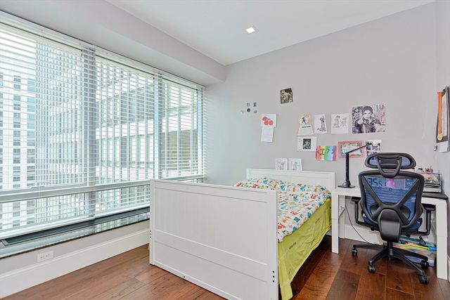 a bedroom with a bed and a desk