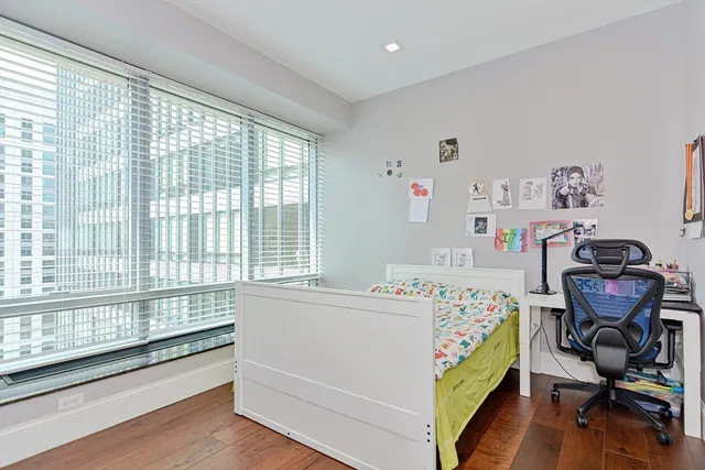 a bedroom with a bed and a desk