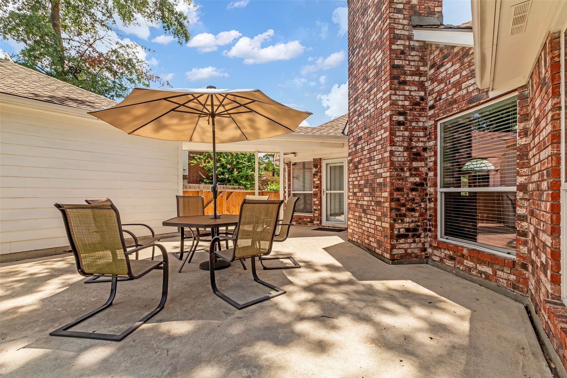 326 North Cypress Estates Circle Spring, TX 77388 - Photo 31 of 39 a view of a patio with a table and chairs under an umbrella
