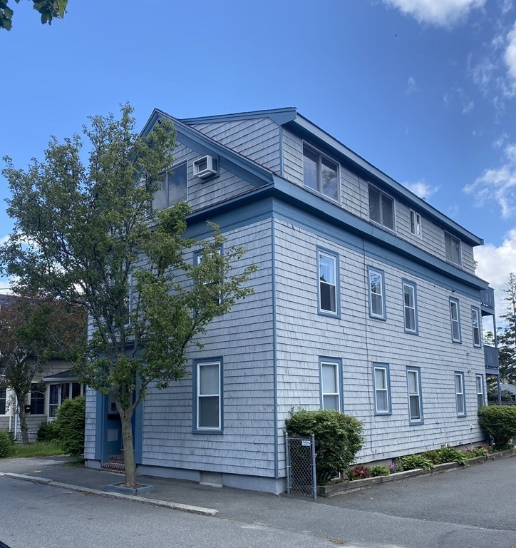 36 Upham Street, Unit 2 Salem, MA 01970 - Photo 2 of 13 a front view of a house with a yard
