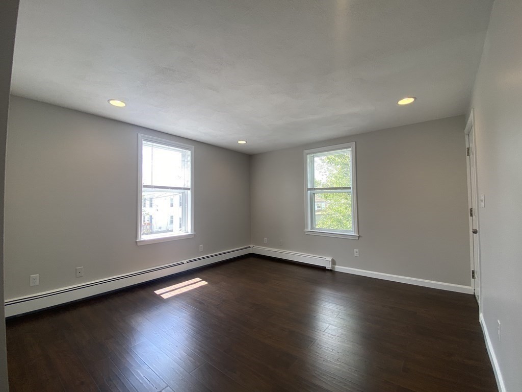 36 Upham Street, Unit 2 Salem, MA 01970 - Photo 4 of 13 wooden floor in an empty room with a window