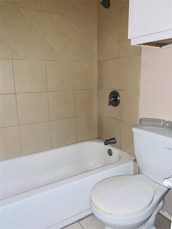 5625 Antoine Drive, Unit 607 Houston, TX 77091 - Photo 9 of 15 a white toilet sitting next to a bath tub and shower
