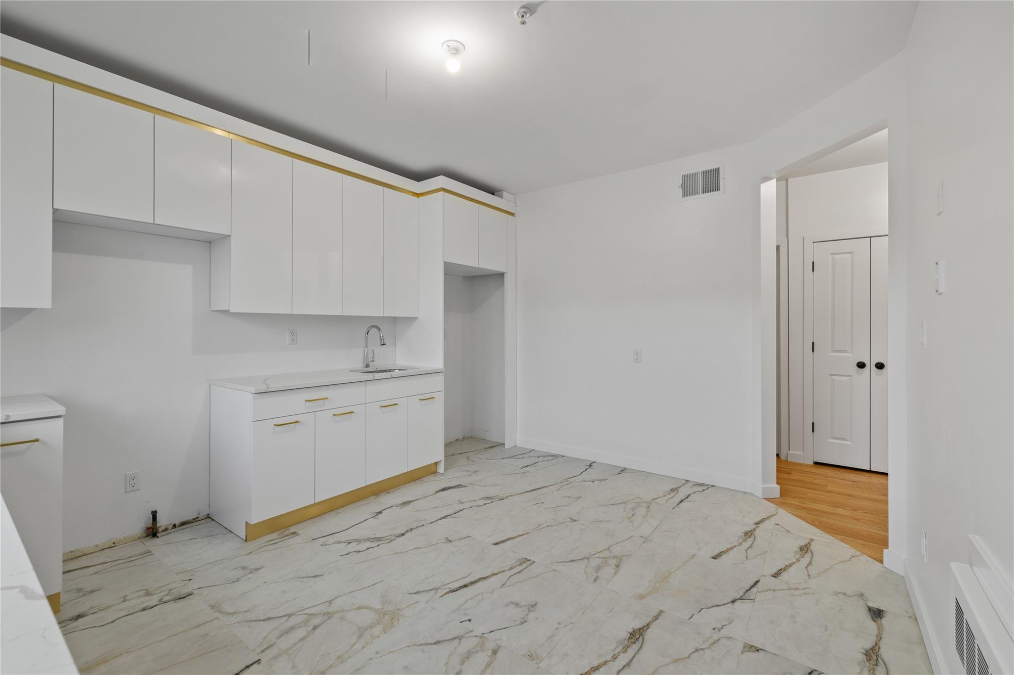 151 Blauvelt Road, Unit 116 Monsey, NY 10952 - Photo 5 of 12 a room with white cabinets and sink