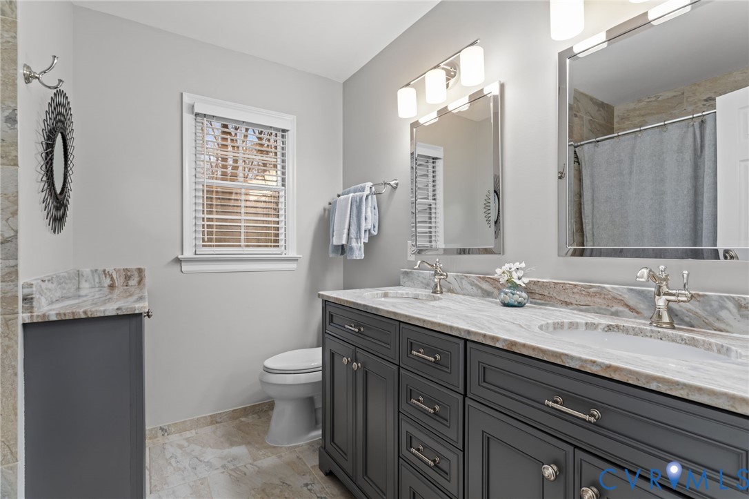 13914 Sagebrook Road Midlothian, VA 23112 - Photo 27 of 49 a bathroom with a granite countertop sink a toilet and a mirror