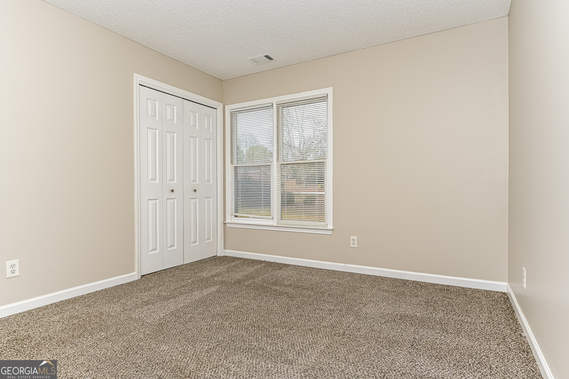 100 Red Maple Drive Hampton, GA 30228 - Photo 14 of 22 a view of an empty room with a window