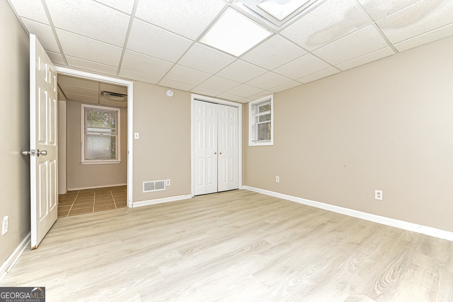 100 Red Maple Drive Hampton, GA 30228 - Photo 19 of 22 a view of an empty room with wooden floor
