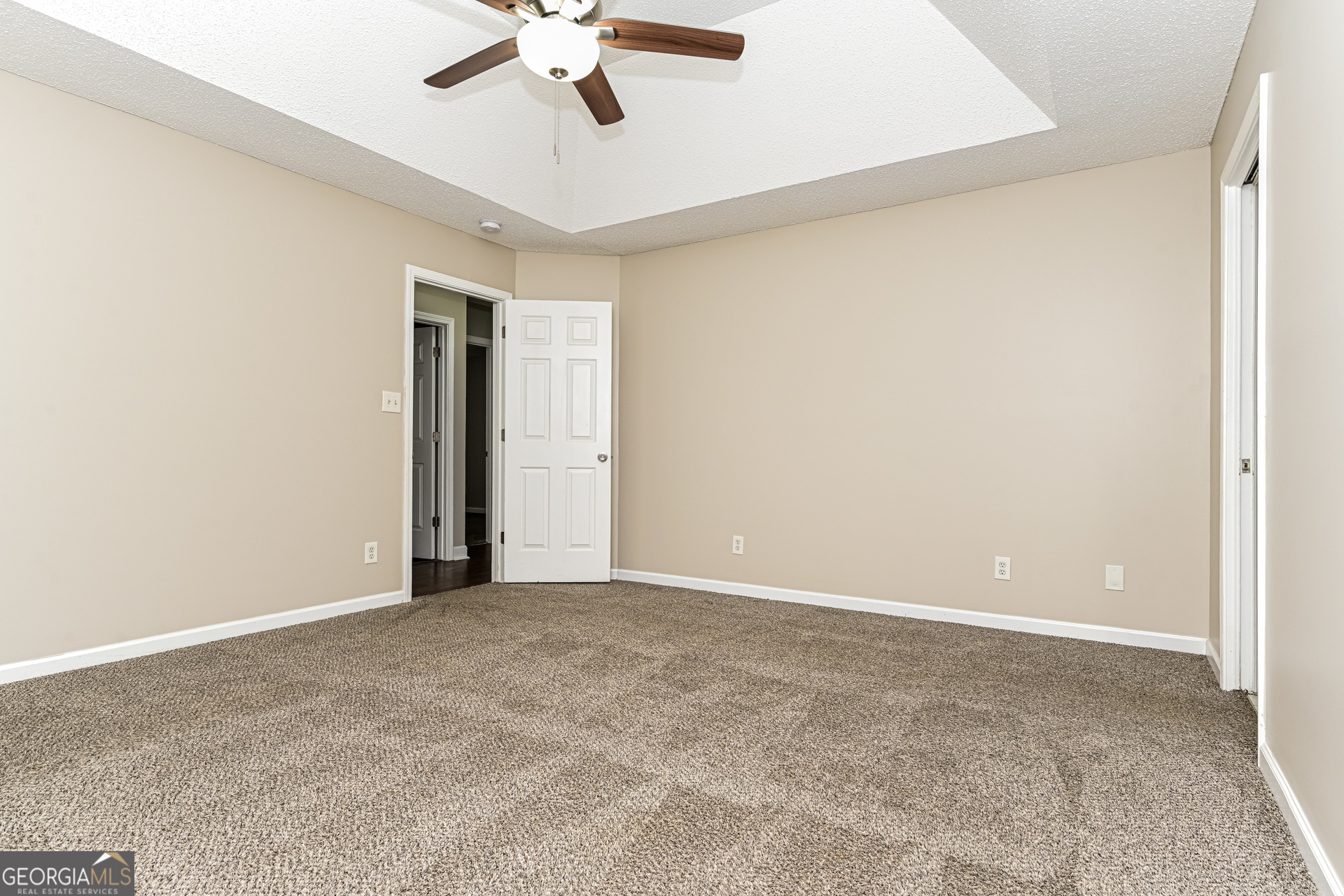 100 Red Maple Drive Hampton, GA 30228 - Photo 9 of 22 a view of an empty room with a ceiling fan