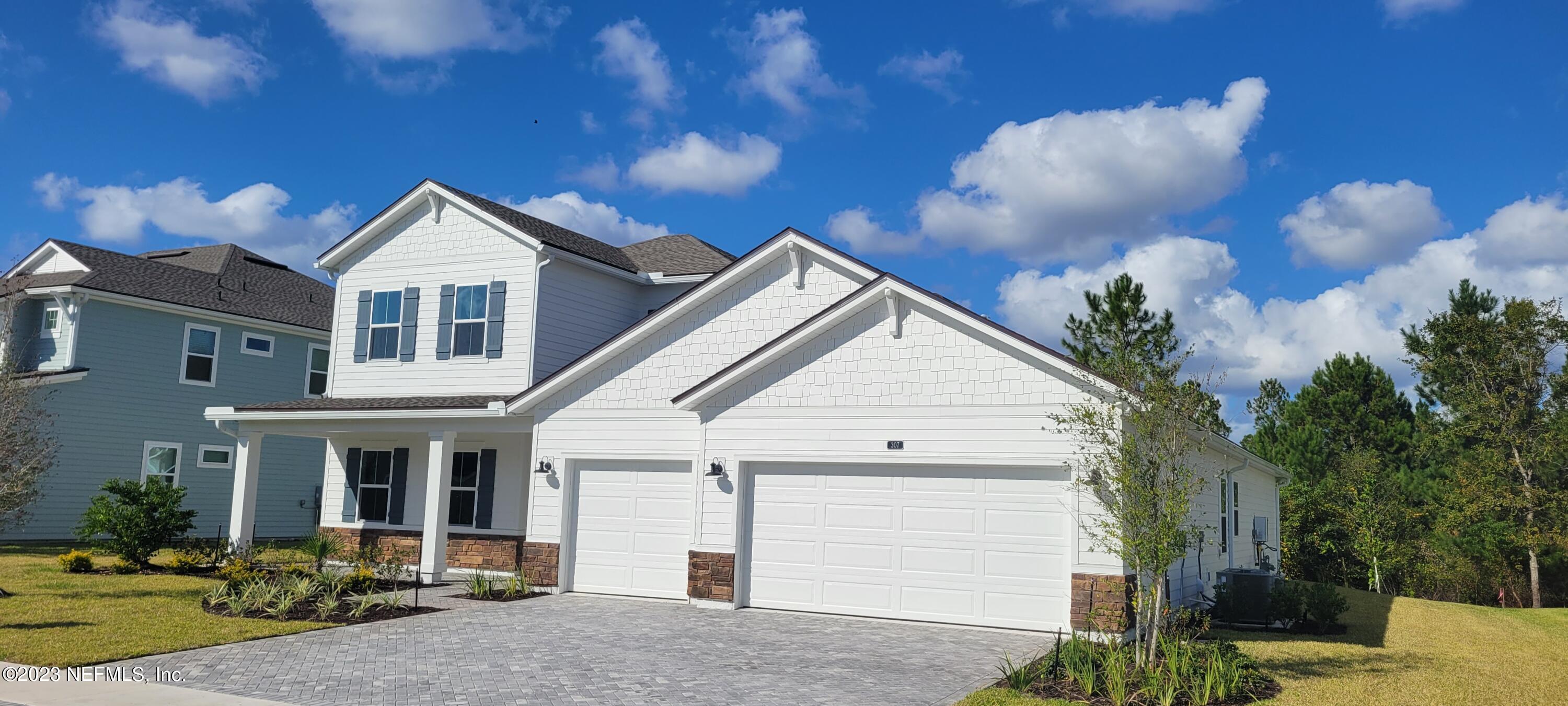 307 Ranch Land Circle St. Johns, FL 32259 - Photo 1 of 95 a front view of a house with garden