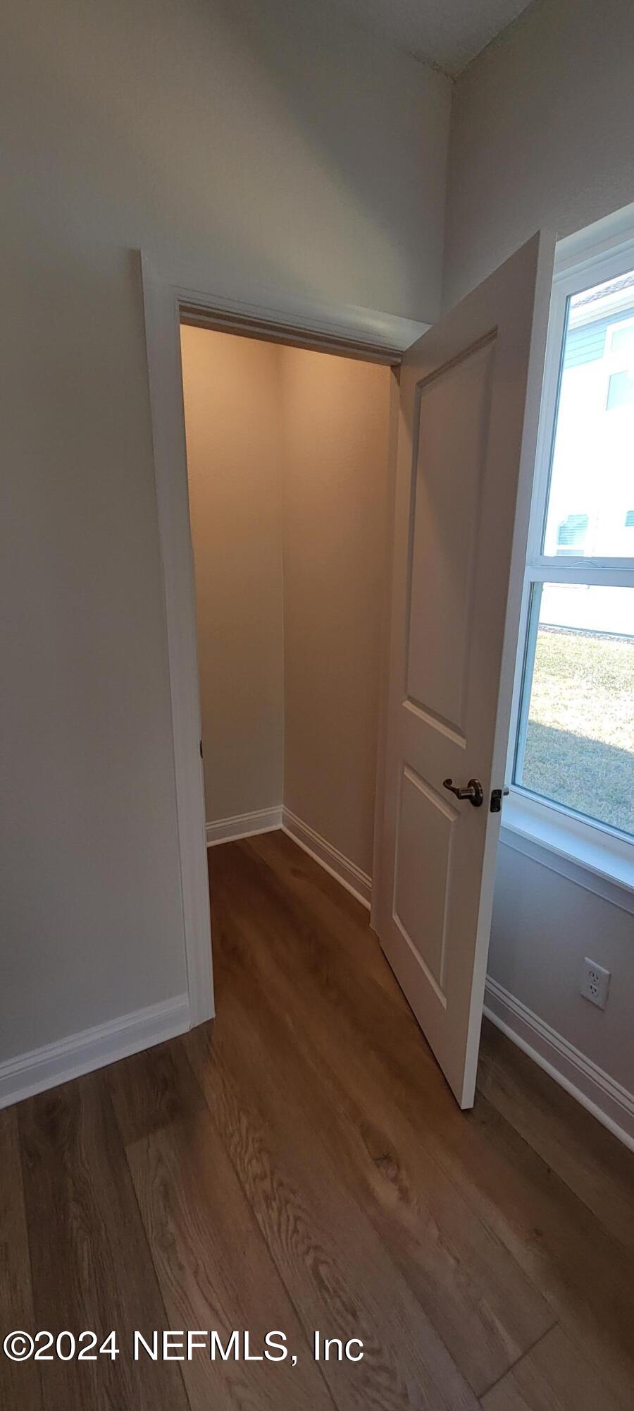 307 Ranch Land Circle St. Johns, FL 32259 - Photo 11 of 95 an empty room with wooden floor and windows