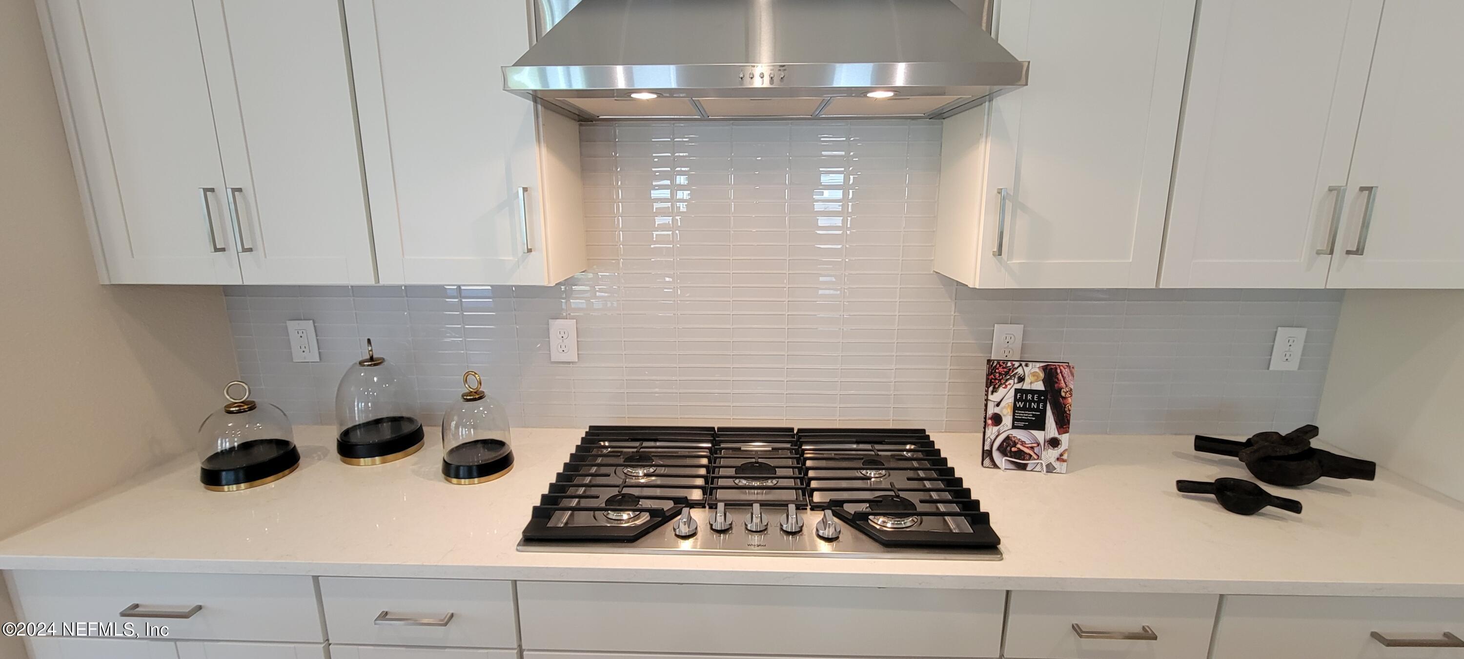 307 Ranch Land Circle St. Johns, FL 32259 - Photo 20 of 95 a kitchen with a stove and white cabinets