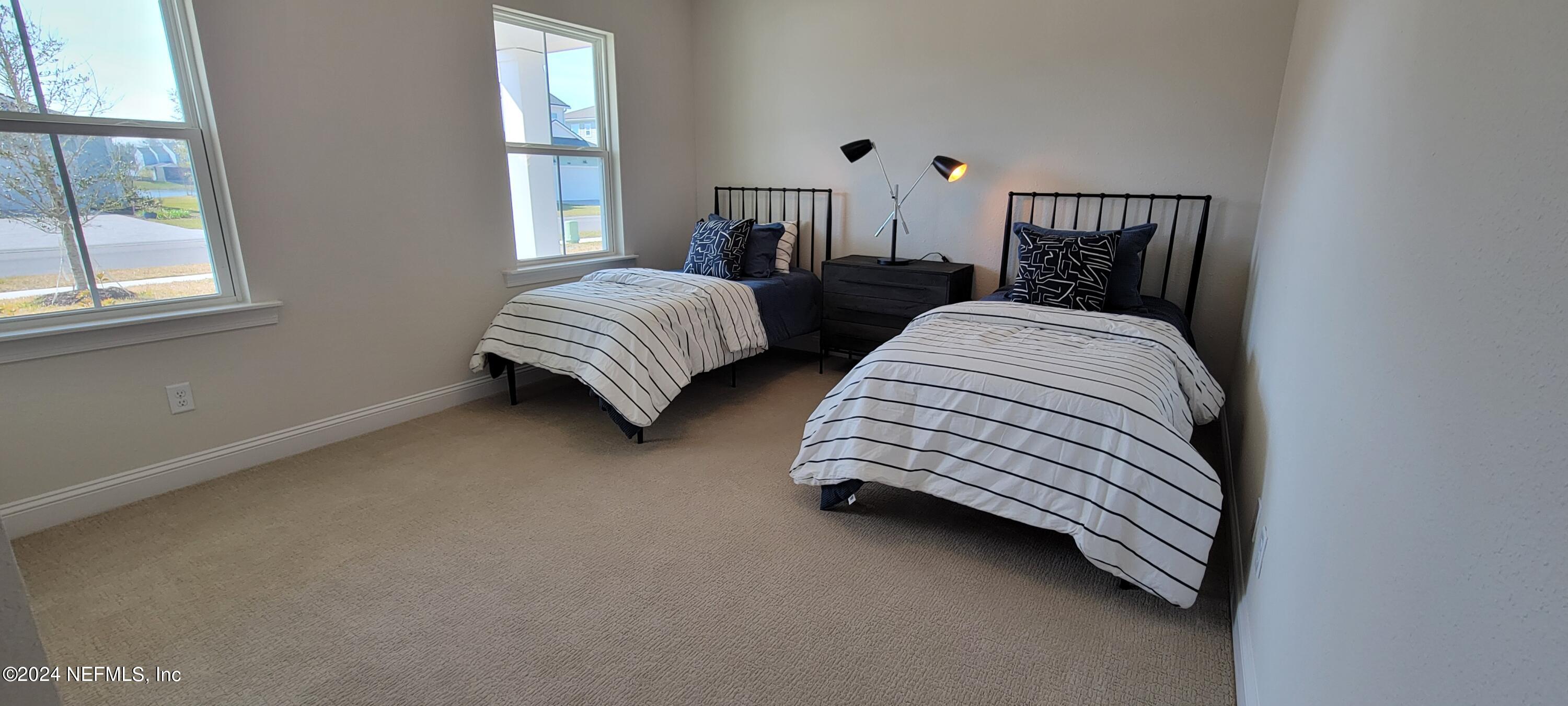 307 Ranch Land Circle St. Johns, FL 32259 - Photo 28 of 95 a bedroom with two beds and a window