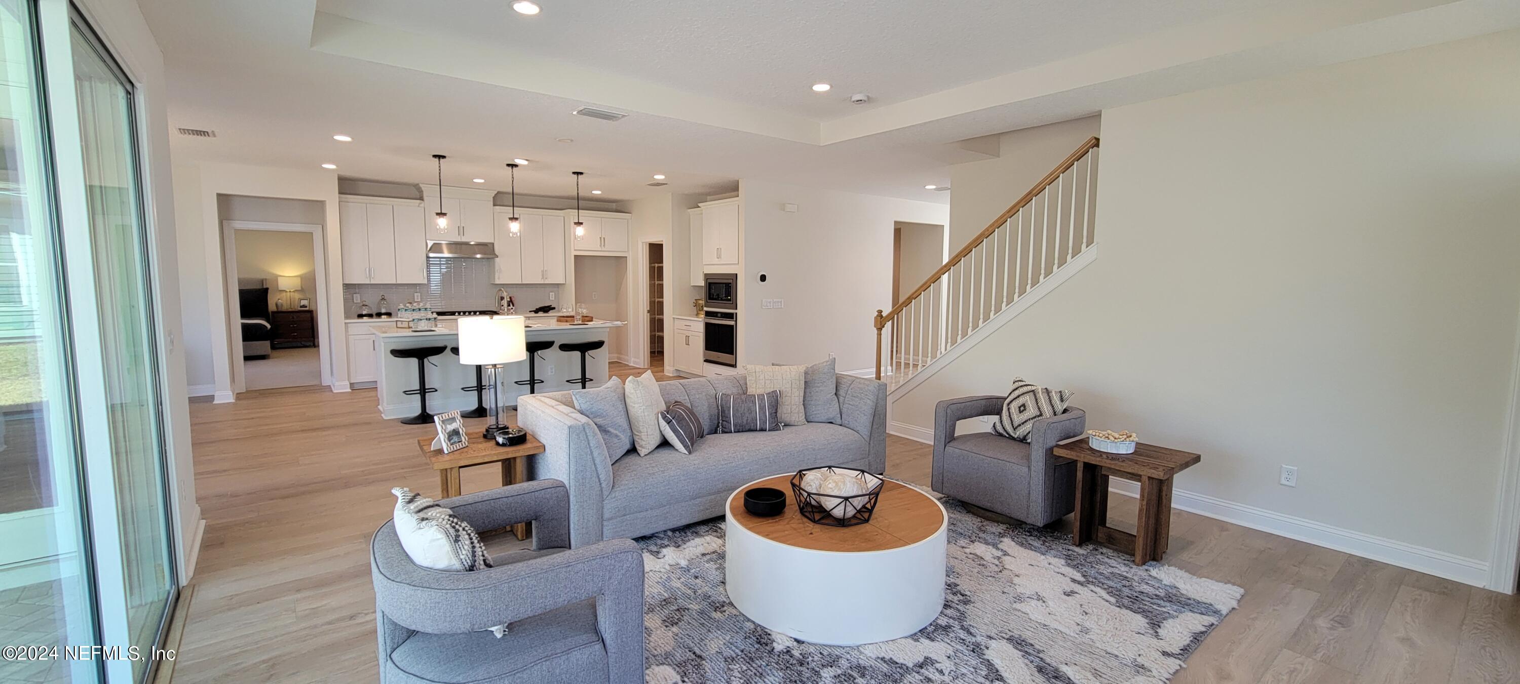 307 Ranch Land Circle St. Johns, FL 32259 - Photo 9 of 95 a living room with furniture and a wooden floor