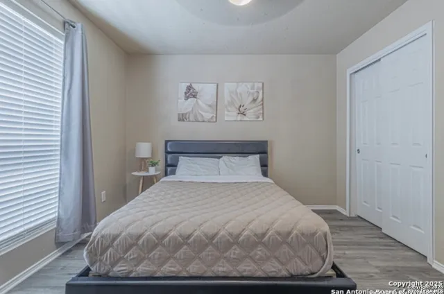 a large bed sitting in a bedroom next to a window