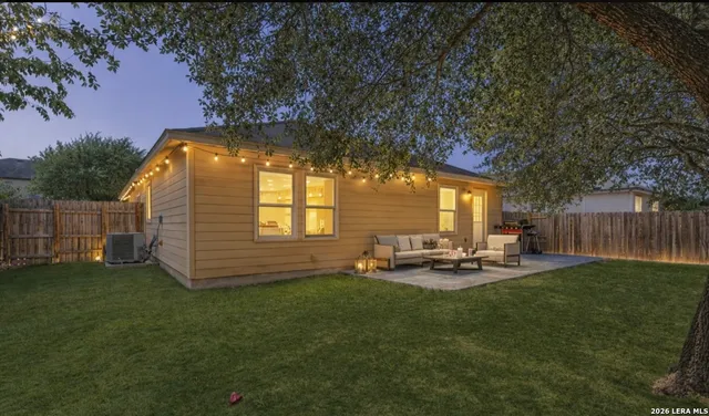 a backyard of a house with table and chairs
