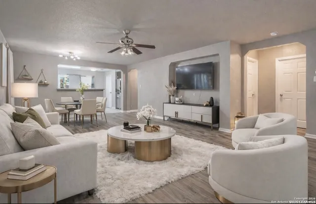 a living room with furniture and a wooden floor