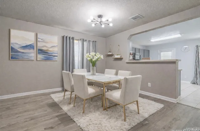 a dining room with furniture a window and wooden floor