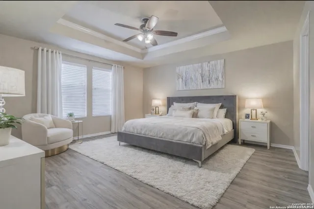 a bedroom with a large bed and a chandelier