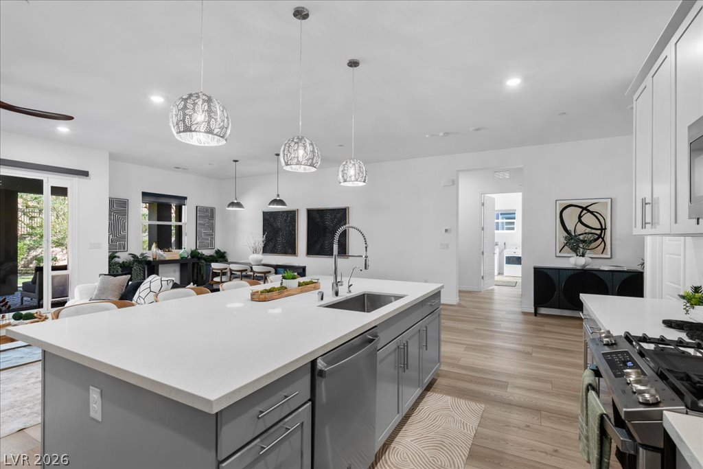 20 Charlotte Ridge Place Henderson, NV 89011 - Photo 12 of 33 A contemporary kitchen and living area blend seamlessly with natural light.