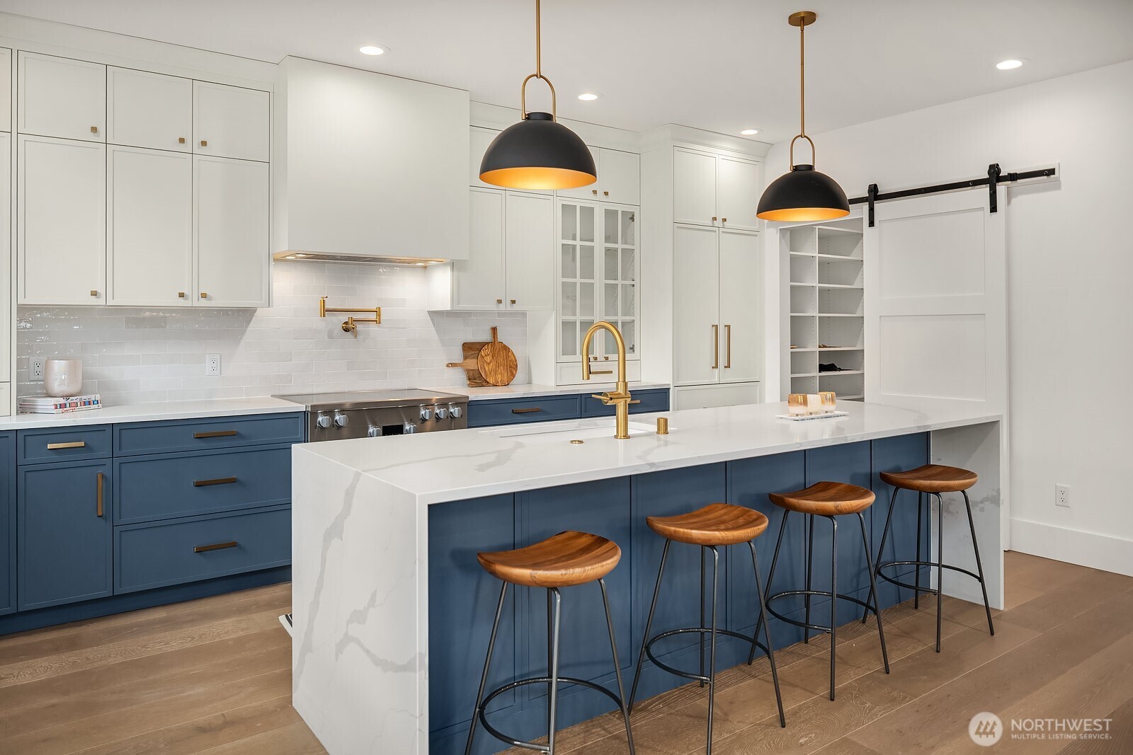2615 Northeast 87th Street Seattle, WA 98115 - Photo 11 of 40 a kitchen with stainless steel appliances kitchen island a table and chairs in it