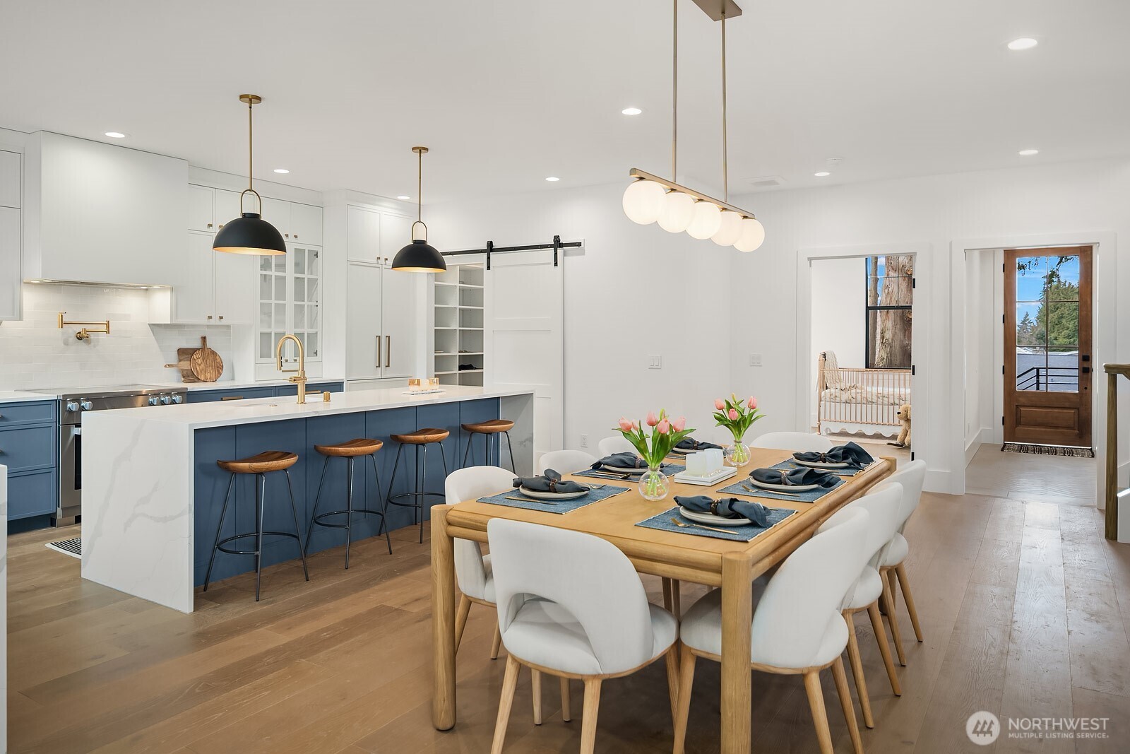 2615 Northeast 87th Street Seattle, WA 98115 - Photo 14 of 40 a kitchen with a dining table chairs sink and wooden floor
