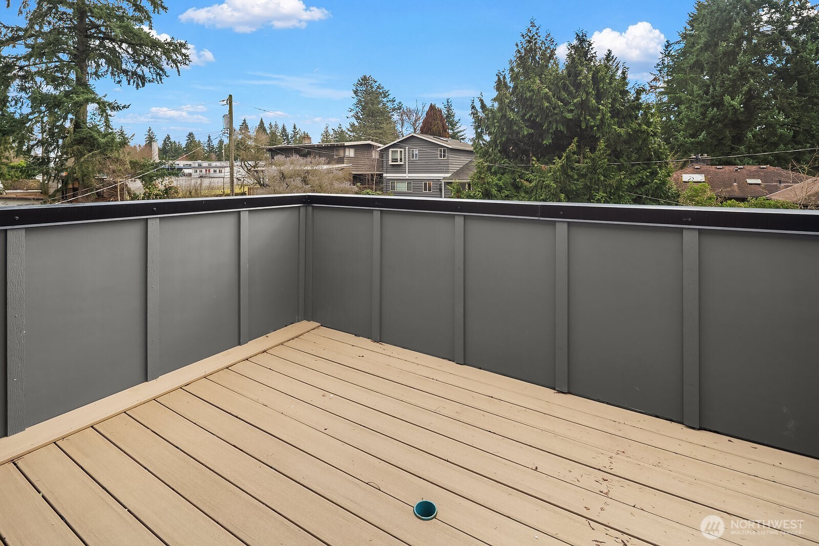 2615 Northeast 87th Street Seattle, WA 98115 - Photo 25 of 40 a view of a balcony with wooden fence and floor