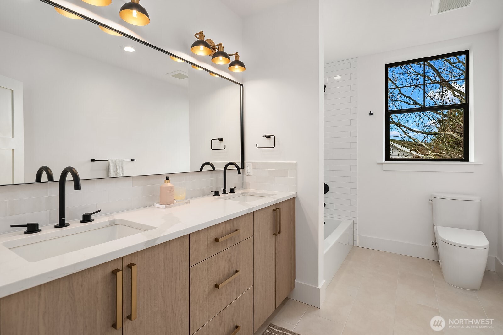 2615 Northeast 87th Street Seattle, WA 98115 - Photo 27 of 40 a bathroom with a toilet sink and mirror