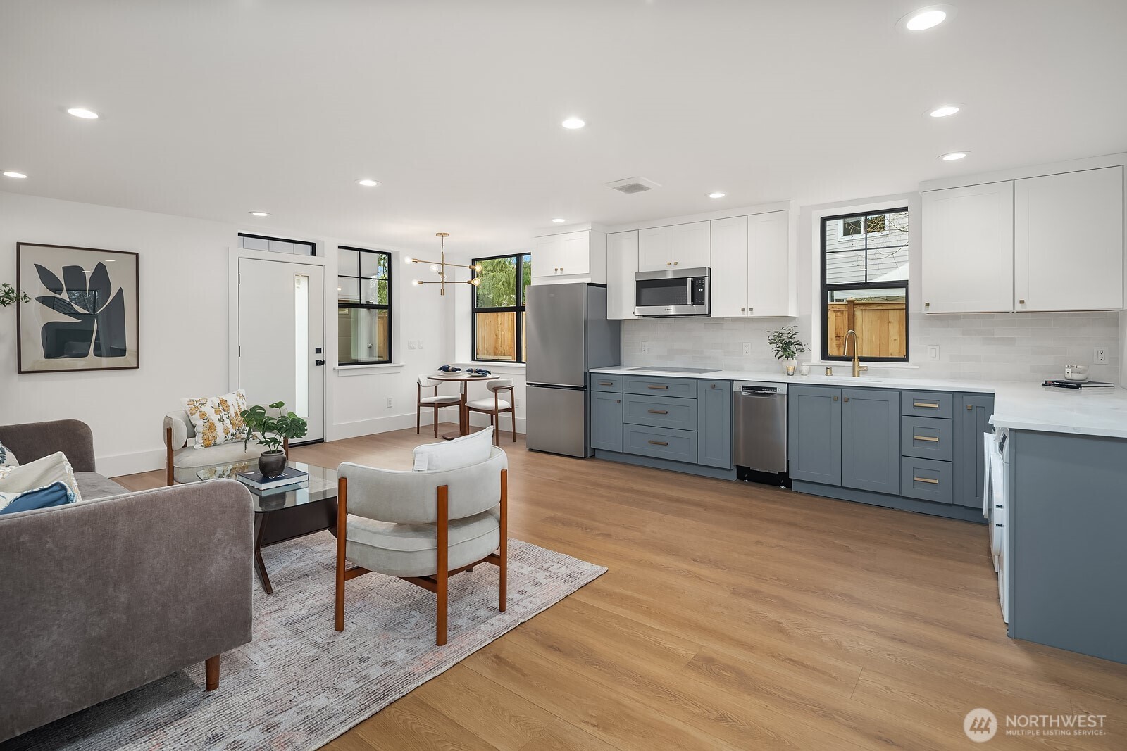 2615 Northeast 87th Street Seattle, WA 98115 - Photo 31 of 40 a living room with furniture wooden floor and kitchen view