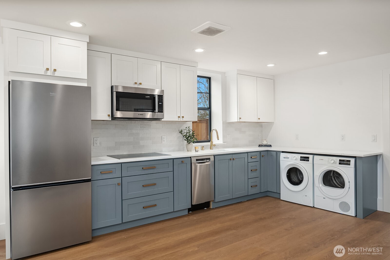 2615 Northeast 87th Street Seattle, WA 98115 - Photo 32 of 40 a kitchen with a refrigerator sink and stove top oven