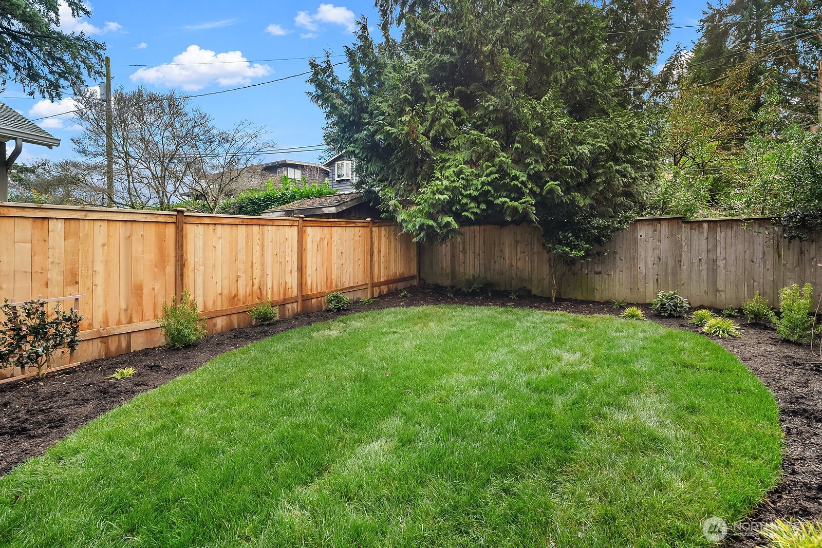 2615 Northeast 87th Street Seattle, WA 98115 - Photo 35 of 40 a view of backyard with potted plants and wooden fence