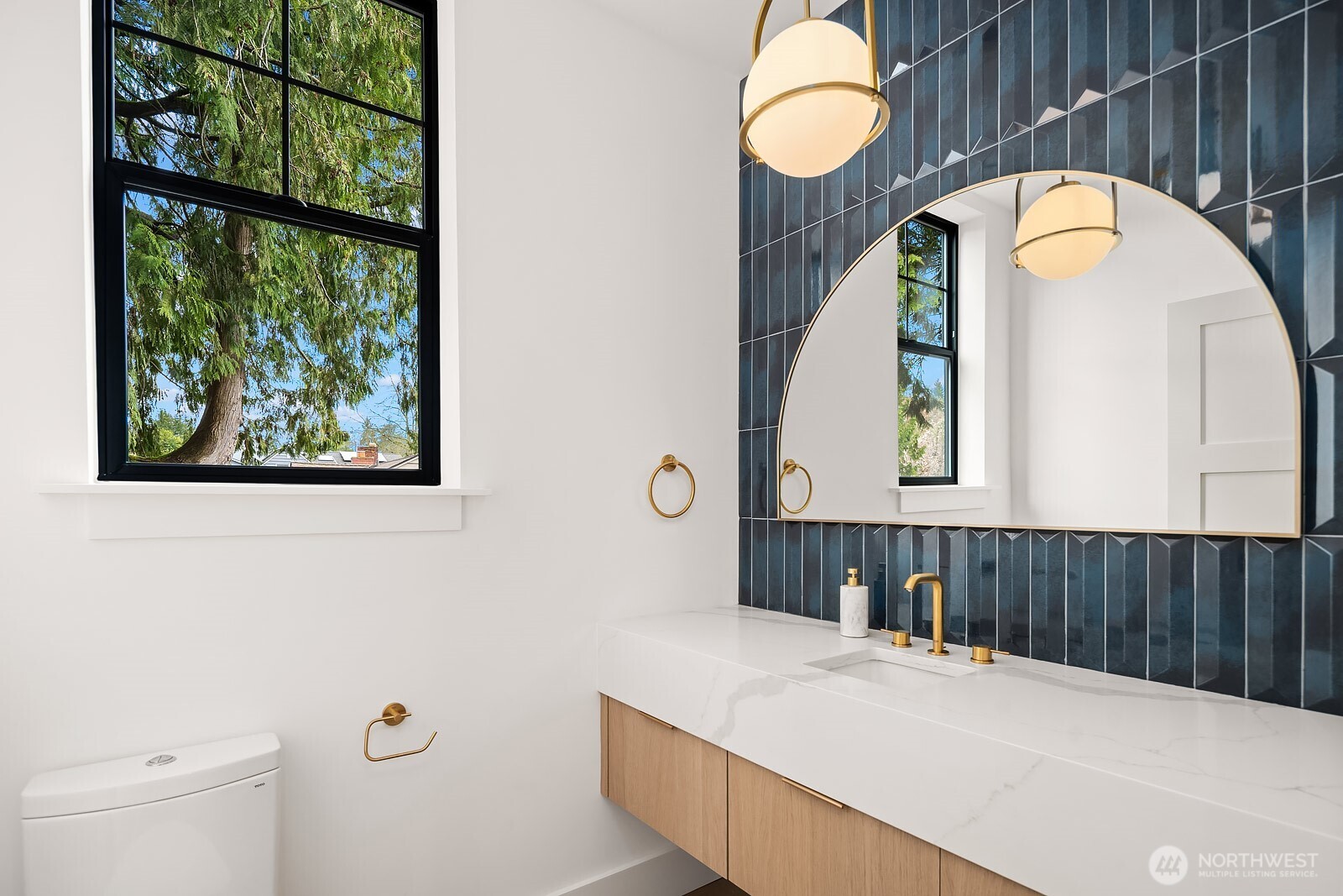 2615 Northeast 87th Street Seattle, WA 98115 - Photo 4 of 40 a view of a bathroom with a sink and a large mirror