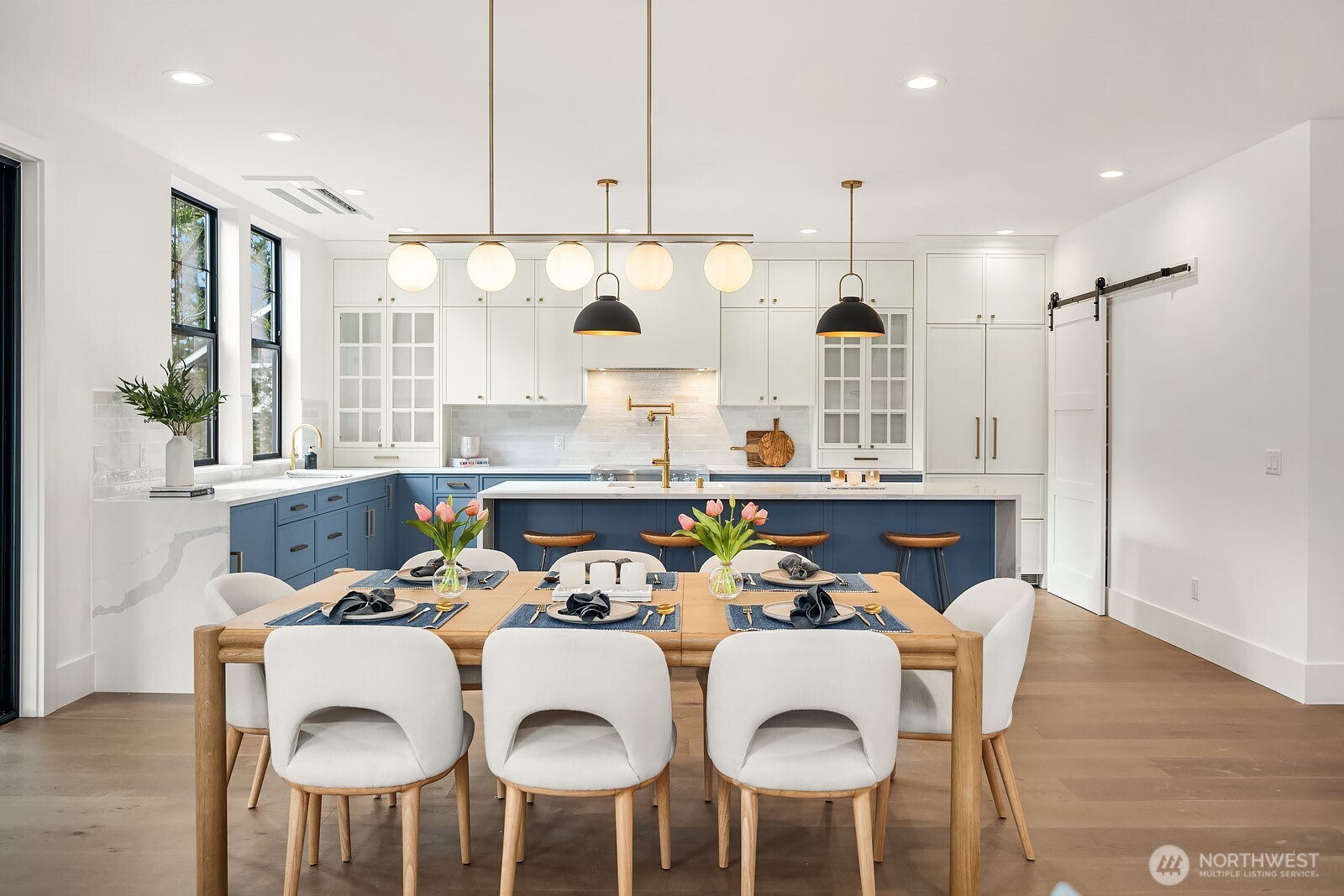 2615 Northeast 87th Street Seattle, WA 98115 - Photo 9 of 40 a kitchen with a dining table chairs and white cabinets