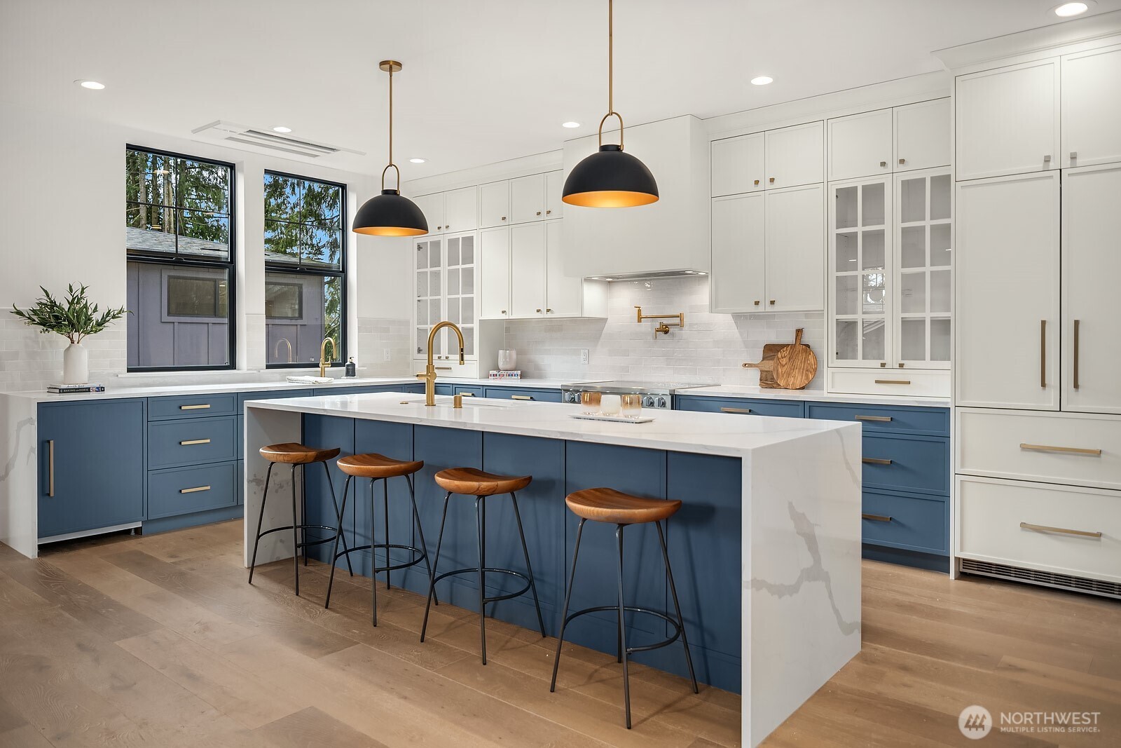 2615 Northeast 87th Street Seattle, WA 98115 - Photo 10 of 40 a kitchen with stainless steel appliances granite countertop a sink a stove and a wooden floors