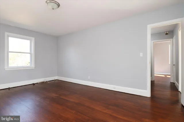 a view of a room with wooden floor and windows