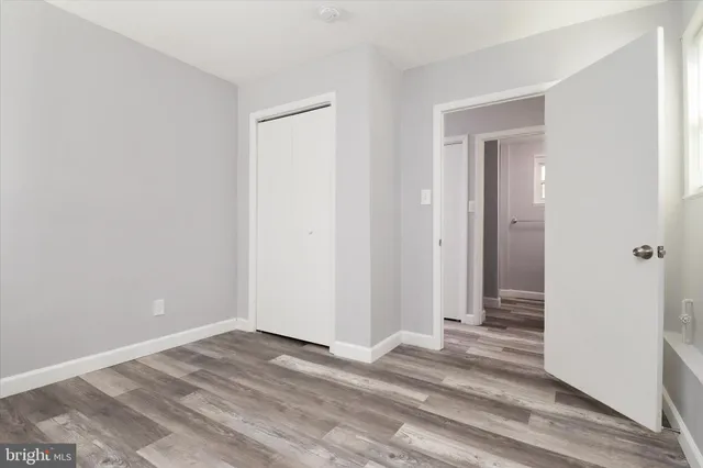 a view of a room with wooden floor and closet