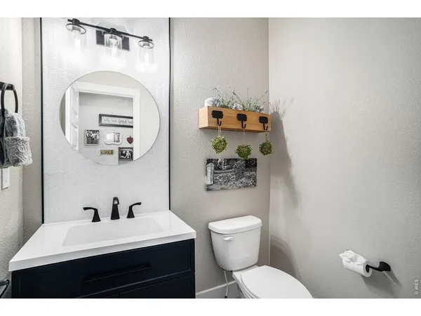 a bathroom with a sink mirror and toilet