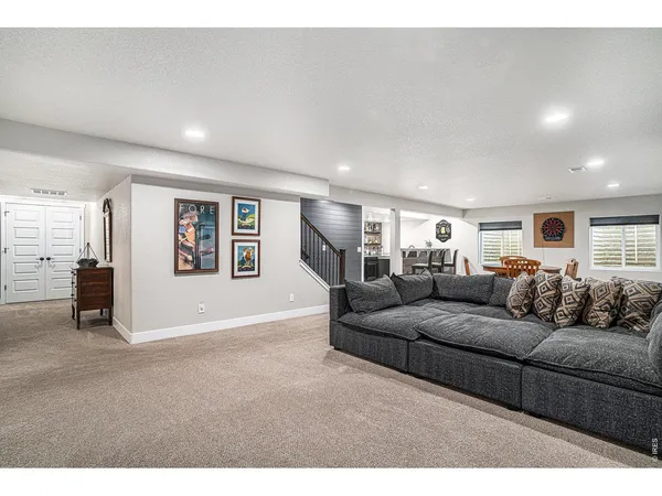 a living room with furniture and a lamp