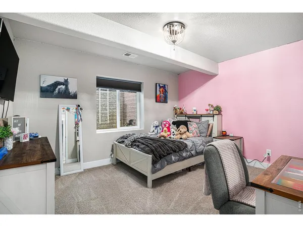 a living room with furniture a flat screen tv and a window