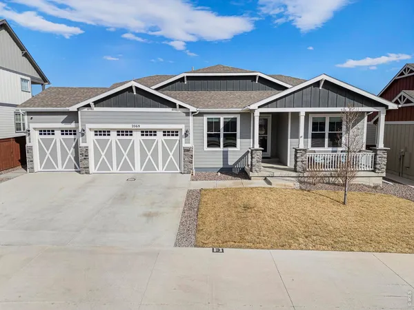 a front view of a house with a yard outdoor seating and garage