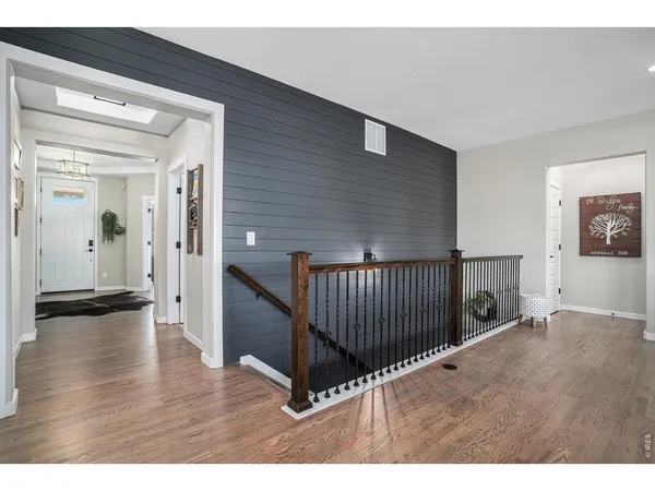 a view of a livingroom with wooden floor and stairs