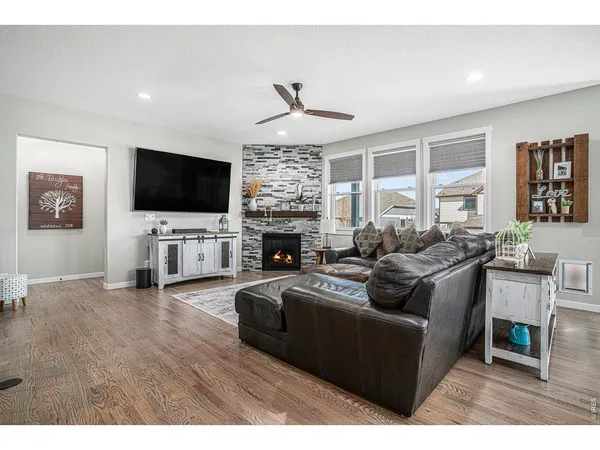 a living room with fireplace furniture and a flat screen tv