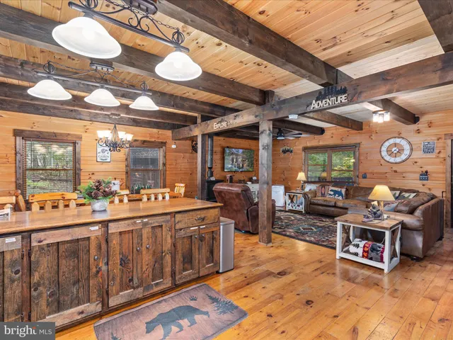 a living room with lots of furniture and a chandelier